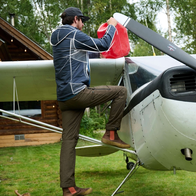 Man wearing Aktivator® Hoody while getting out of car.