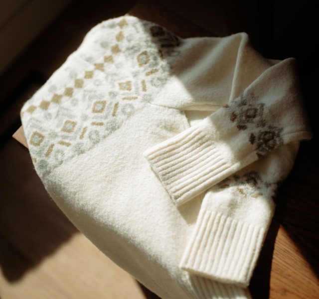 A woman wearing a Kühl Norda™ 1/4 Zip Sweater.