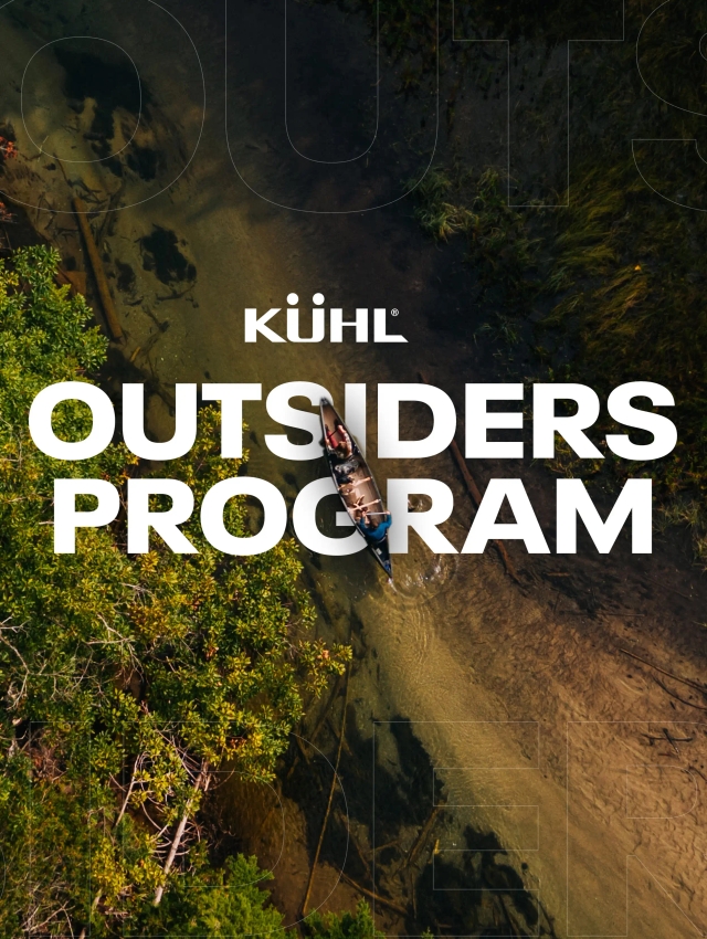 Two people sailing on a river wearing Kühl clothes.