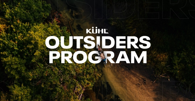 Two people sailing on a river wearing Kühl clothes.